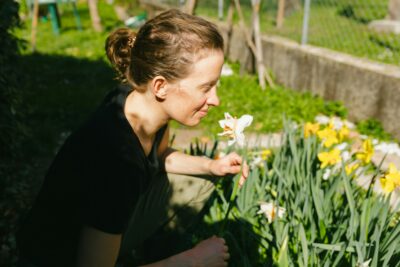 A women smelling flowers