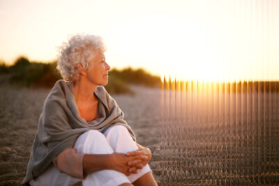 A picture of an old women looking into the sunset